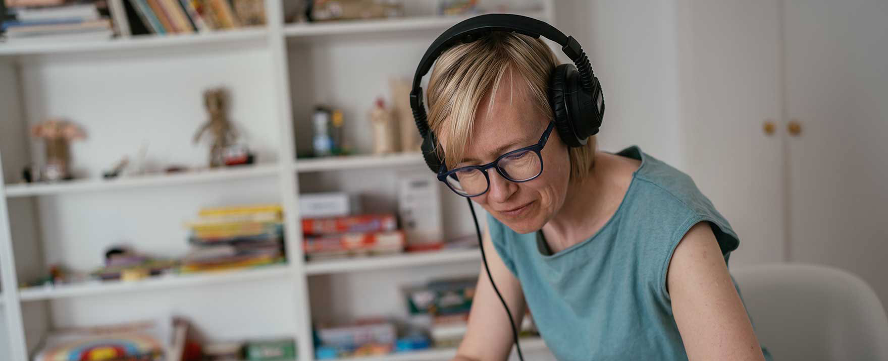 blond adult woman sitting with the earphones