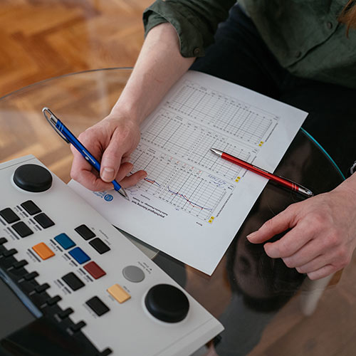 Sheet of paper with Tomatis listening test graphs on the glass transparent table
